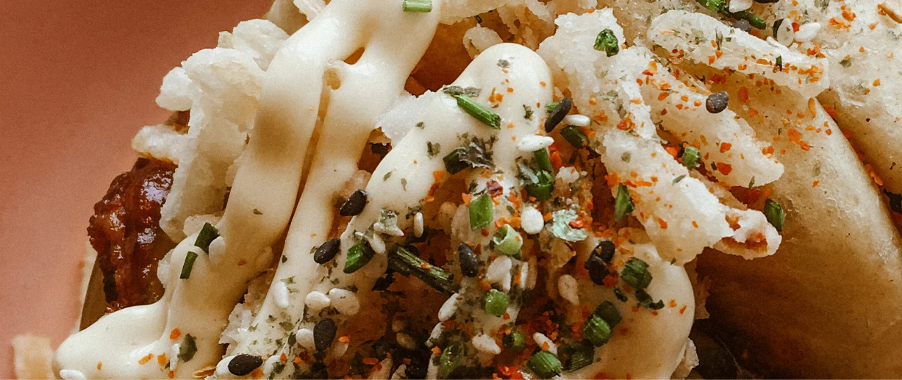 Bao buns served with fresh garnishes
