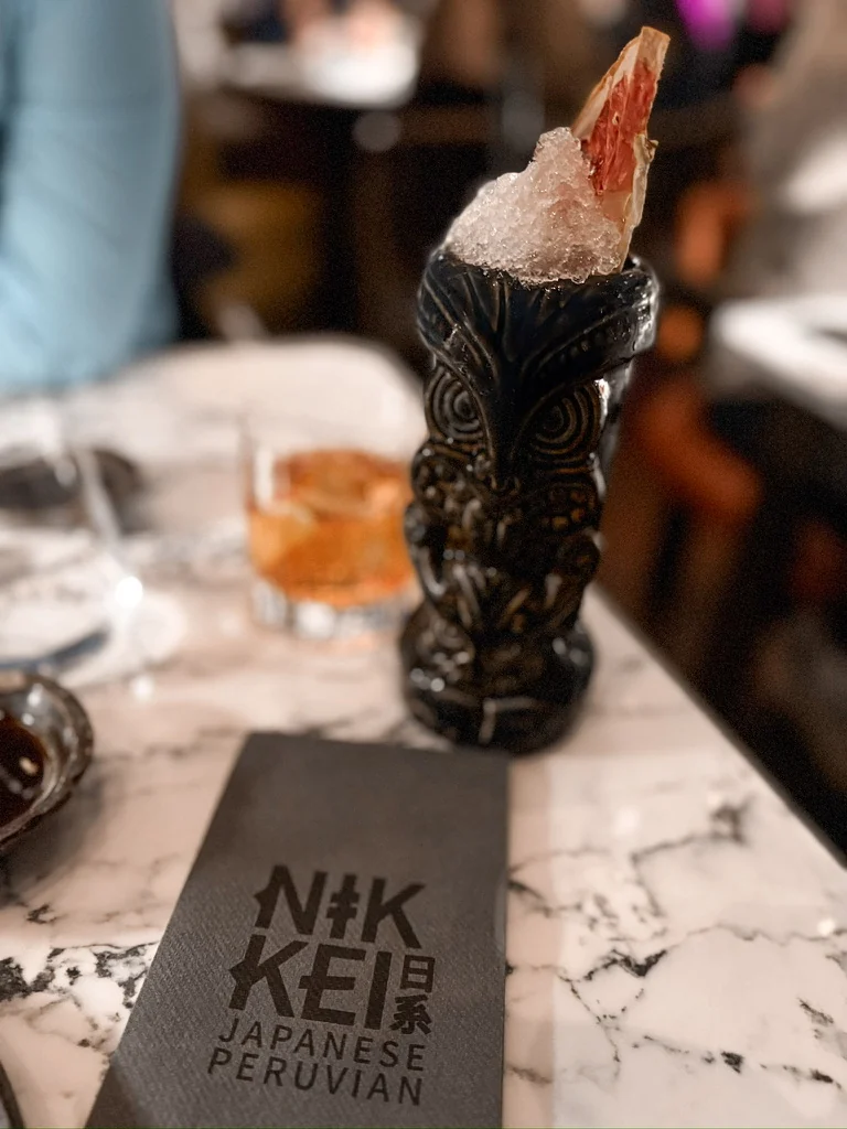Cocktail served in a black tiki glass at Nikkei
